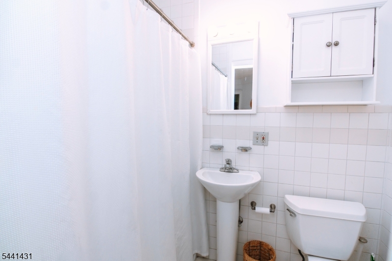 306 Springfield Avenue, Unit 1 Summit, NJ 07901 - Photo 12 of 17 a bathroom with a sink toilet and mirror