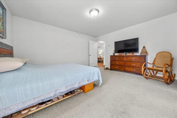 a bedroom with bed and flat screen tv