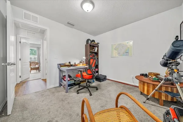 a living room with furniture a flat screen tv and a wooden floor