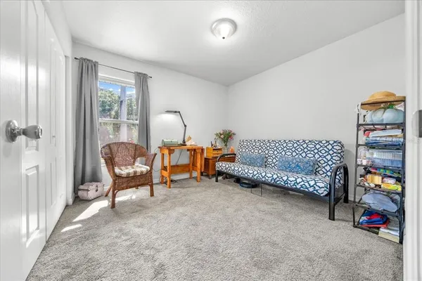 a bedroom with furniture and a lamp