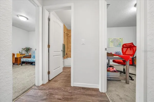 a view of a room that has a bed and a tv in it