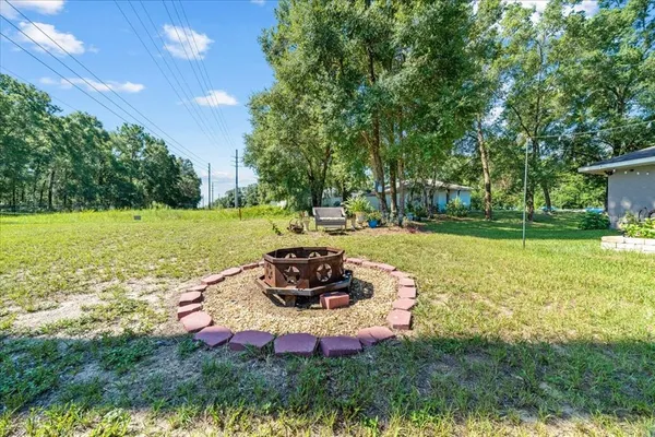 a backyard of a house with a yard and outdoor seating