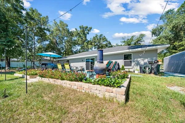 a front view of house with a garden and patio