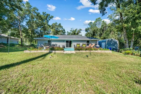 a view of a house with swimming pool and a yard