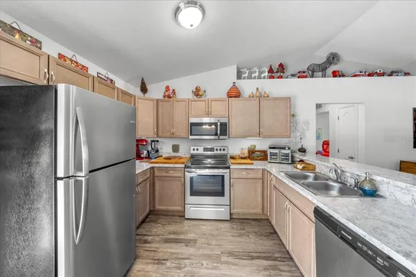 a kitchen with a refrigerator and a sink