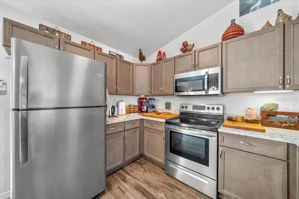 a kitchen with stainless steel appliances granite countertop a refrigerator sink and microwave