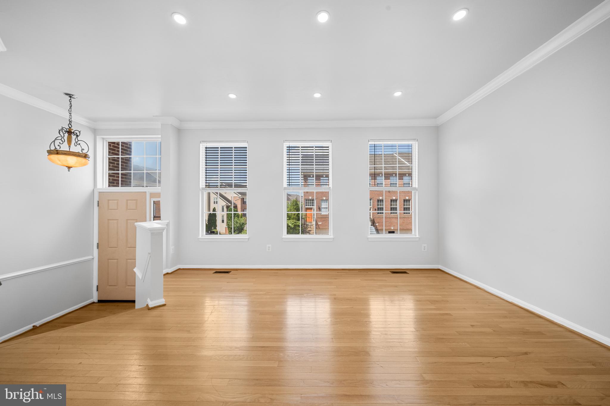 2631 Tarleton Corner Drive Herndon, VA 20171 - Photo 2 of 41 a view of an empty room with glass door and wooden floor