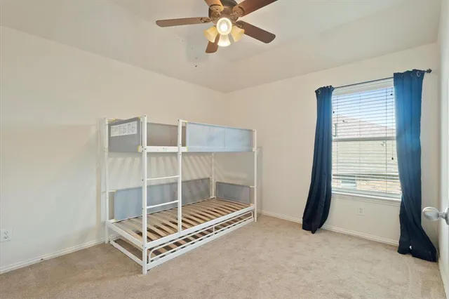 a view of room with window and ceiling fan