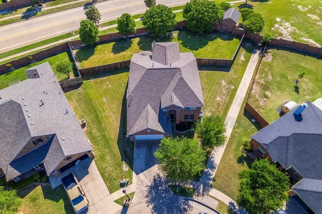 an aerial view of a house with a swimming pool