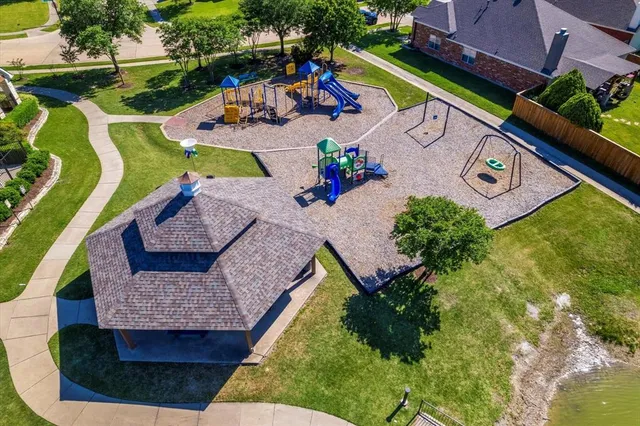 an aerial view of a house a yard swimming pool and outdoor seating
