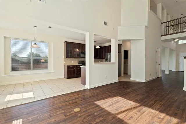 a view of a kitchen with wooden floor and a kitchen