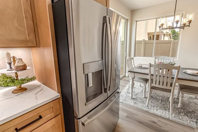 a kitchen with stainless steel appliances granite countertop a refrigerator and a stove top oven
