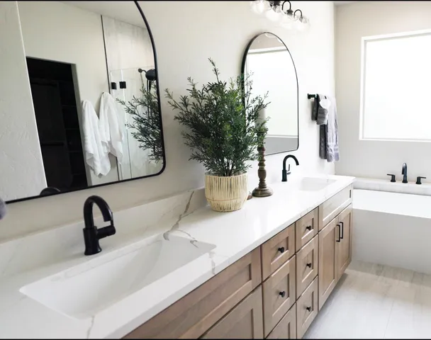 a bathroom with a double vanity sink and a mirror