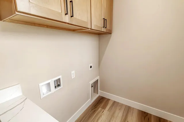 a view of a kitchen with white cabinets