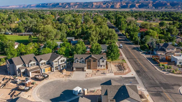 an aerial view of a house with garden space and street view