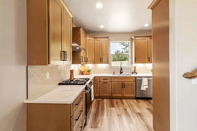 a kitchen with a sink stove and cabinets