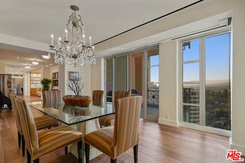 a view of a dining room with furniture wooden floor and chandelier