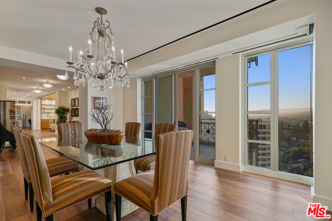 10580 Wilshire Boulevard, Unit 23NE Los Angeles, CA 90024 - Photo 13 of 42 a view of a dining room with furniture wooden floor and chandelier