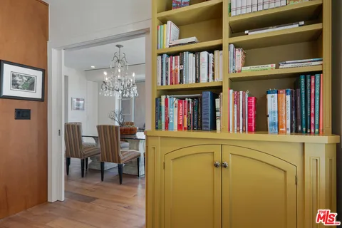 a living room with lots of books and furniture