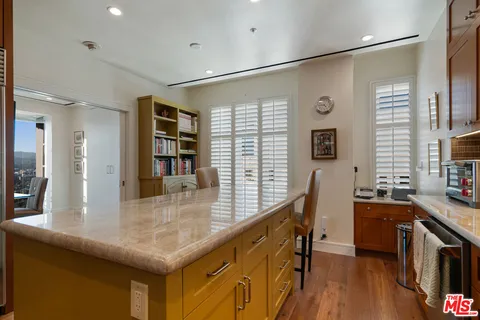 a kitchen with counter top space and windows