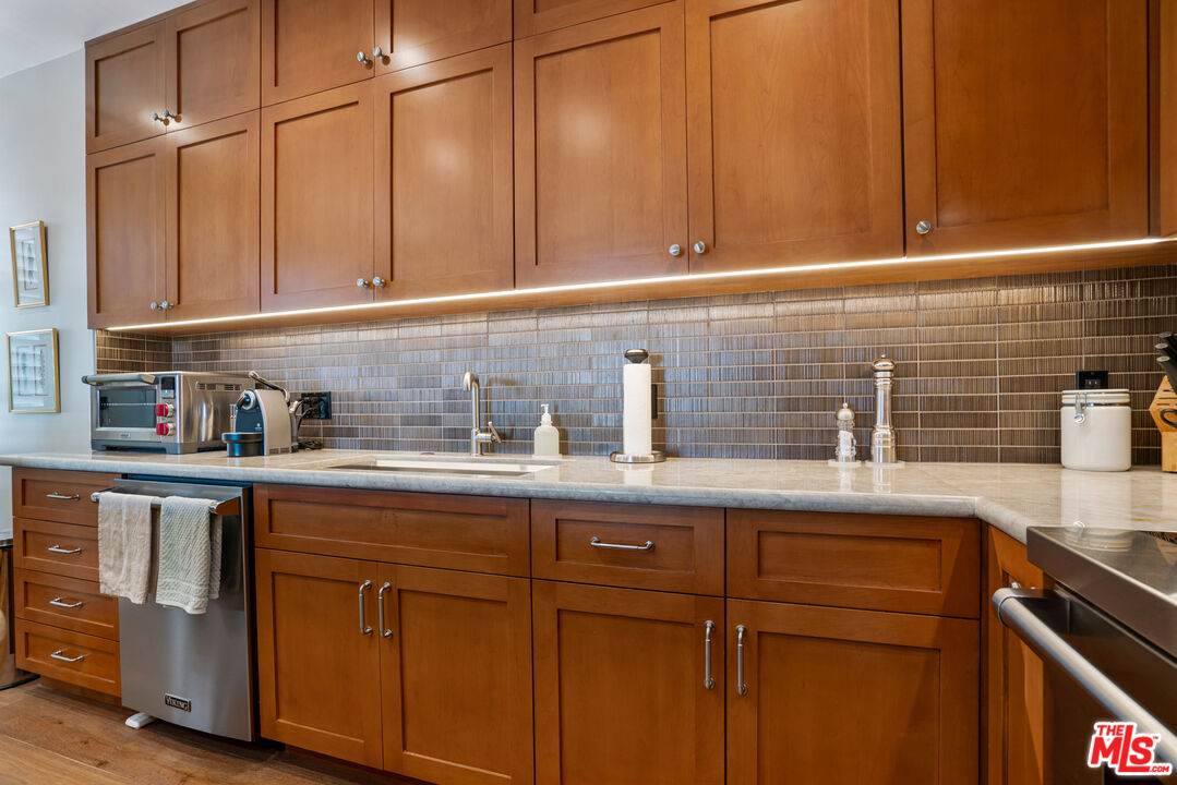 10580 Wilshire Boulevard, Unit 23NE Los Angeles, CA 90024 - Photo 18 of 42 a kitchen with stainless steel appliances granite countertop a sink and cabinets