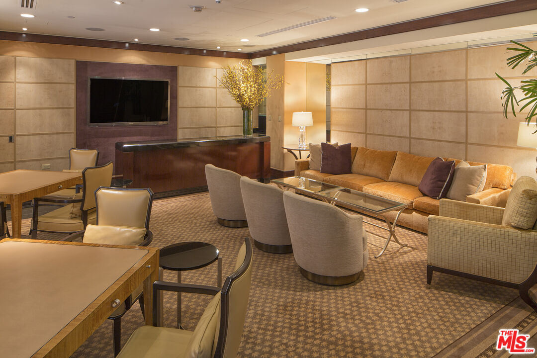 10580 Wilshire Boulevard, Unit 23NE Los Angeles, CA 90024 - Photo 36 of 42 a living room with furniture and a flat screen tv