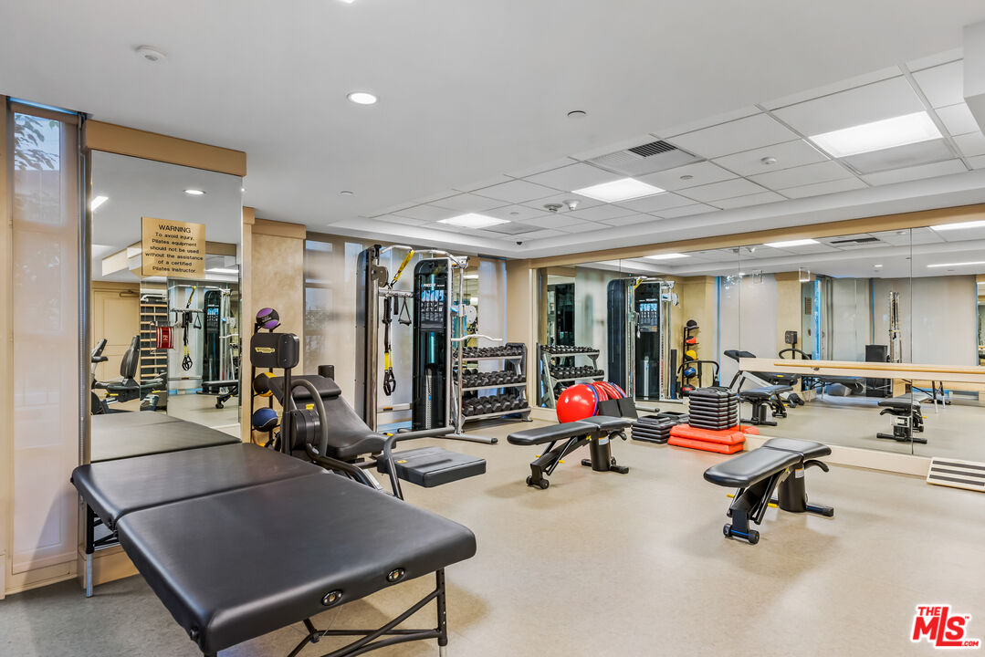 10580 Wilshire Boulevard, Unit 23NE Los Angeles, CA 90024 - Photo 40 of 42 a view of a room with gym equipment