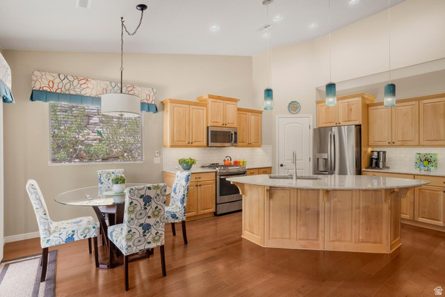 1587 Whitestone Drive St. George, UT 84790 - Photo 8 of 36 Open-concept kitchen featuring wood-finish flooring and light-toned cabinetry