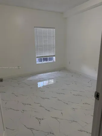 an empty room with a empty space and windows