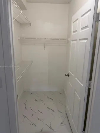 a bathroom with a shower and a glass door