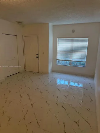 an empty room with a empty space and windows