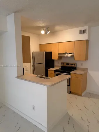 a kitchen with a refrigerator and a stove