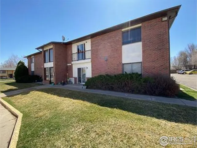 a front view of a house with yard and green space