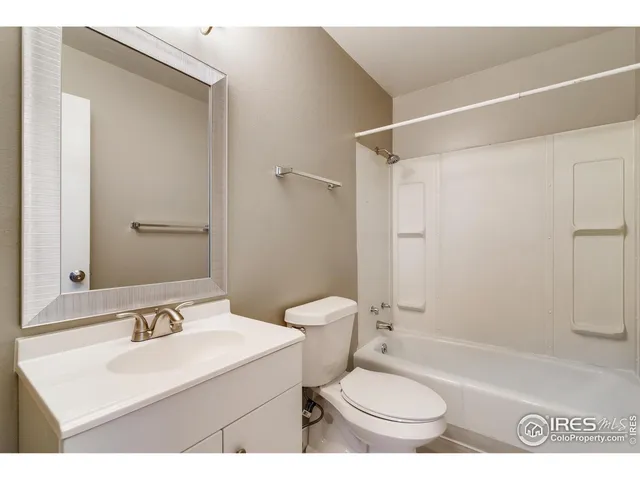 a bathroom with a sink toilet vanity and shower