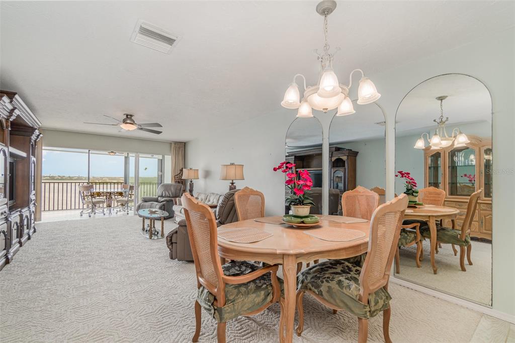 9011 Midnight Pass Road, Unit 329 Sarasota, FL 34242 - Photo 13 of 39 a view of a dining room with furniture window and outside view