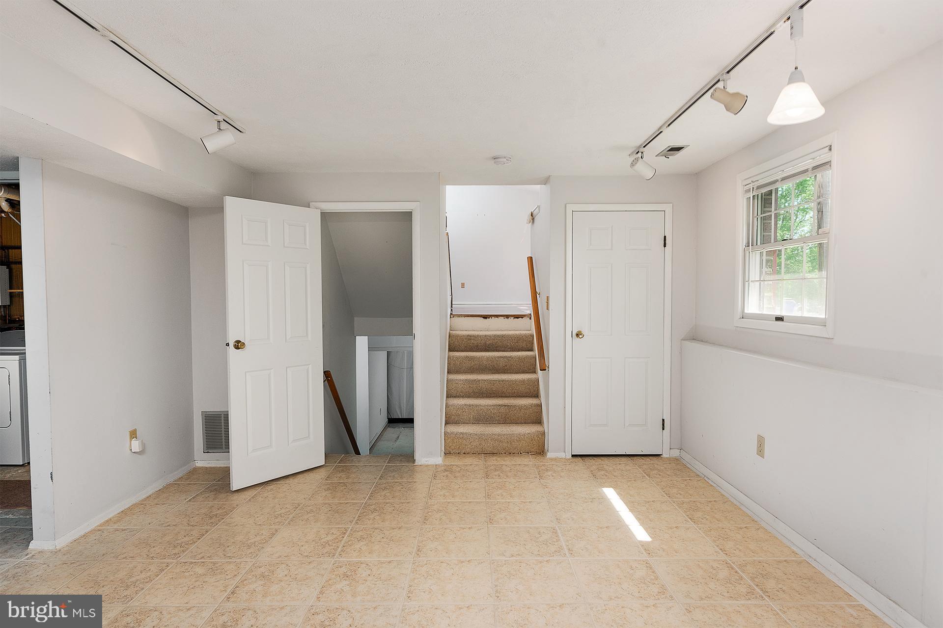 9438 Northgate Road Laurel, MD 20723 - Photo 11 of 40 Lower level with fireplace bathroom and a room