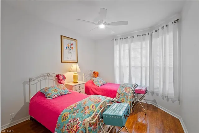 a bedroom with a large bed and a flat tv screen on dresser