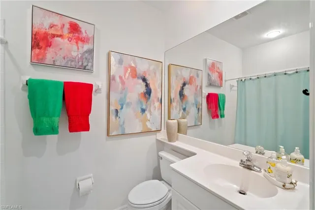 a bedroom with a bed lamps and window