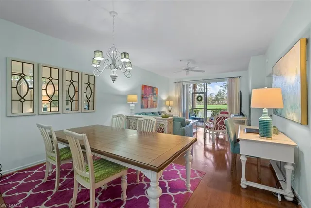 a living room with furniture a flat screen tv and a large window