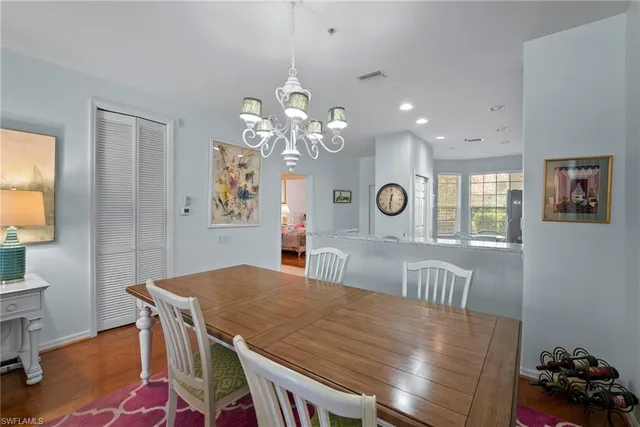 a kitchen with stainless steel appliances granite countertop a sink and a refrigerator