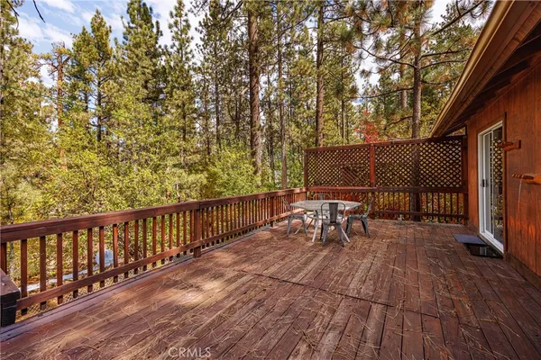a view of a chairs and table on the wooden deck