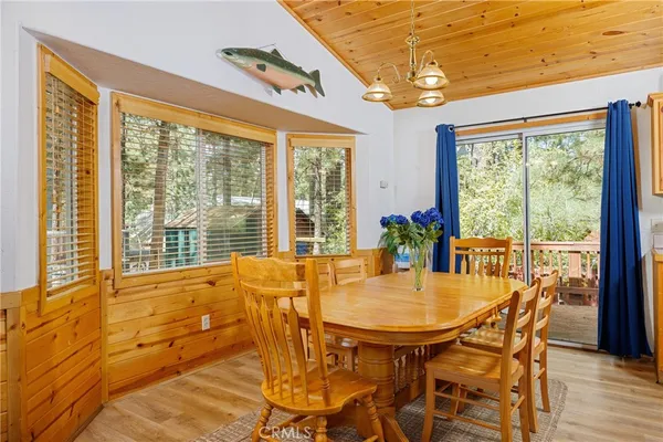 a dining room with furniture and large windows