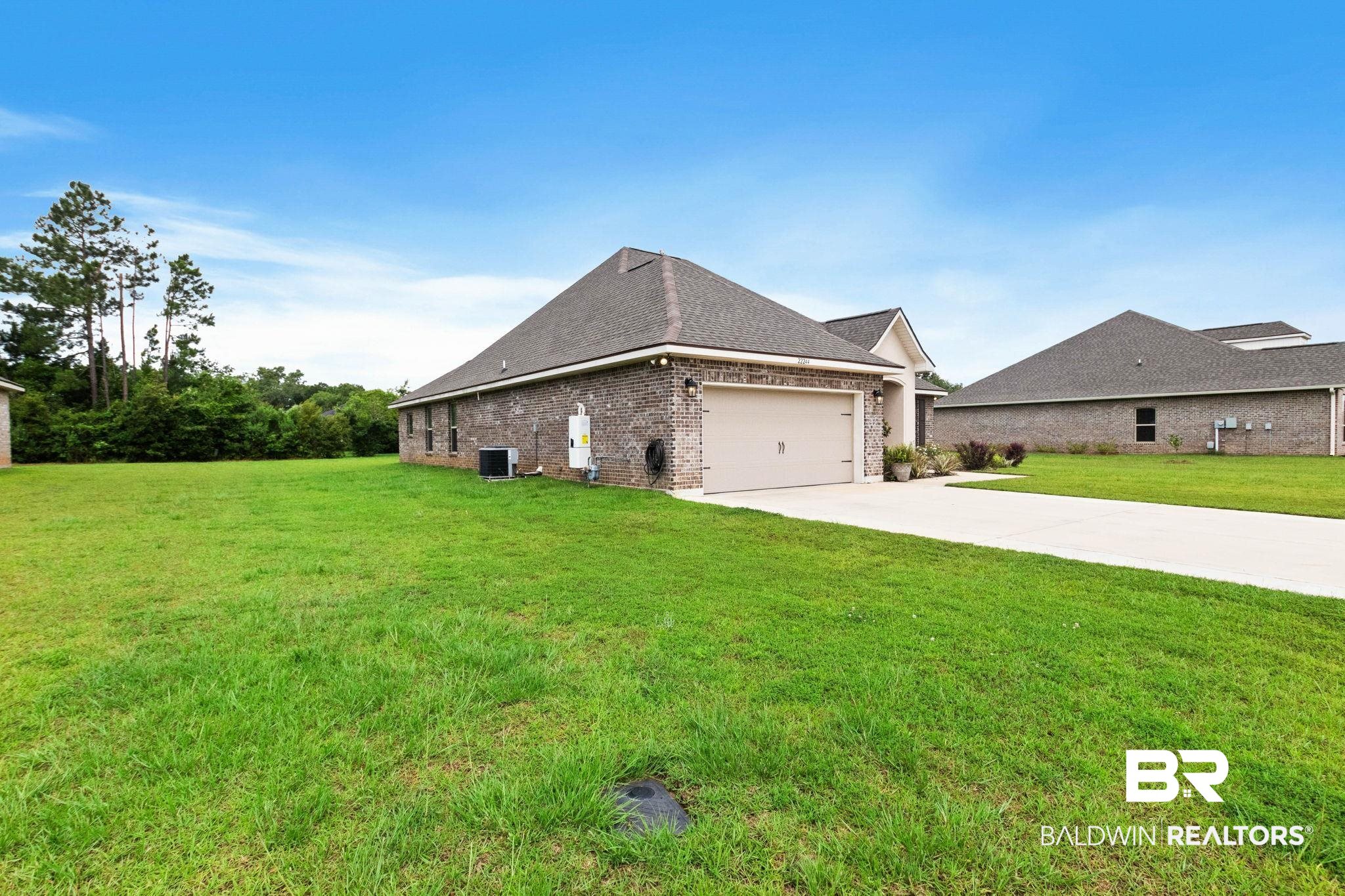 22244 Hibiscus Circle Foley, AL 36535 - Photo 4 of 51 Brick exterior with a side-facing garage and a concrete driveway