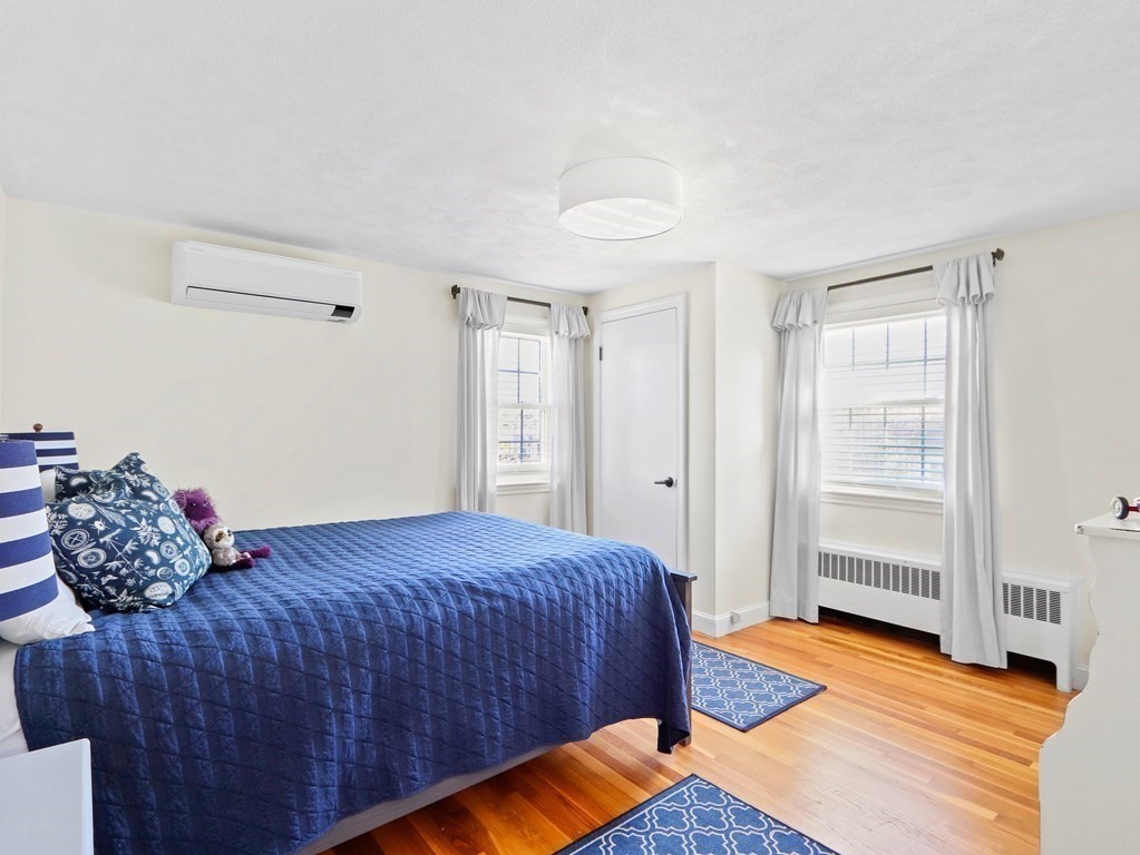 93 Meadowbrook Road Needham, MA 02492 - Photo 17 of 34 a bedroom with a bed and wooden floor