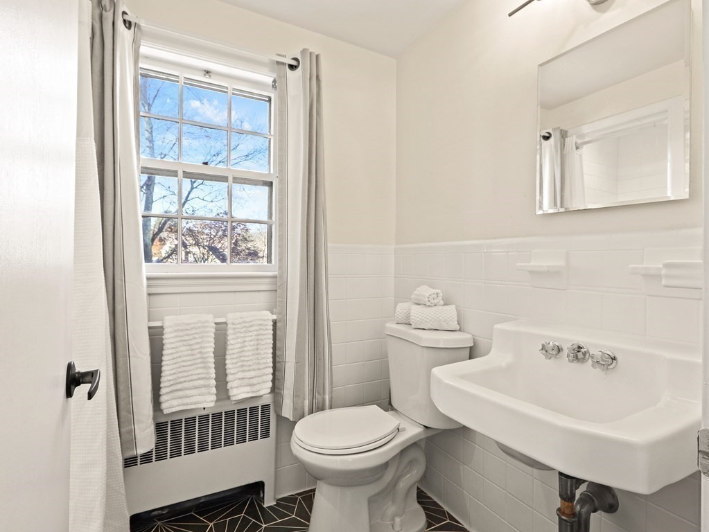 93 Meadowbrook Road Needham, MA 02492 - Photo 24 of 34 a bathroom with a sink toilet and shower