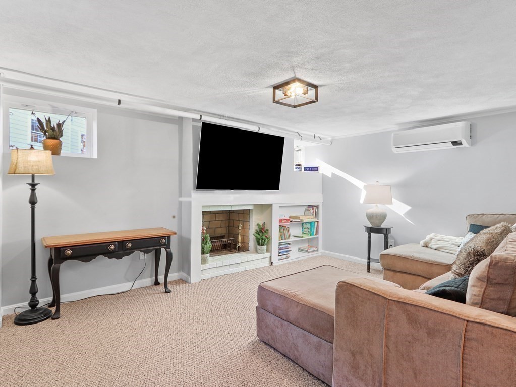 93 Meadowbrook Road Needham, MA 02492 - Photo 25 of 34 a living room with furniture and a flat screen tv