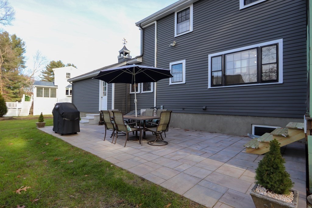 93 Meadowbrook Road Needham, MA 02492 - Photo 27 of 34 a backyard of a house with table and chairs