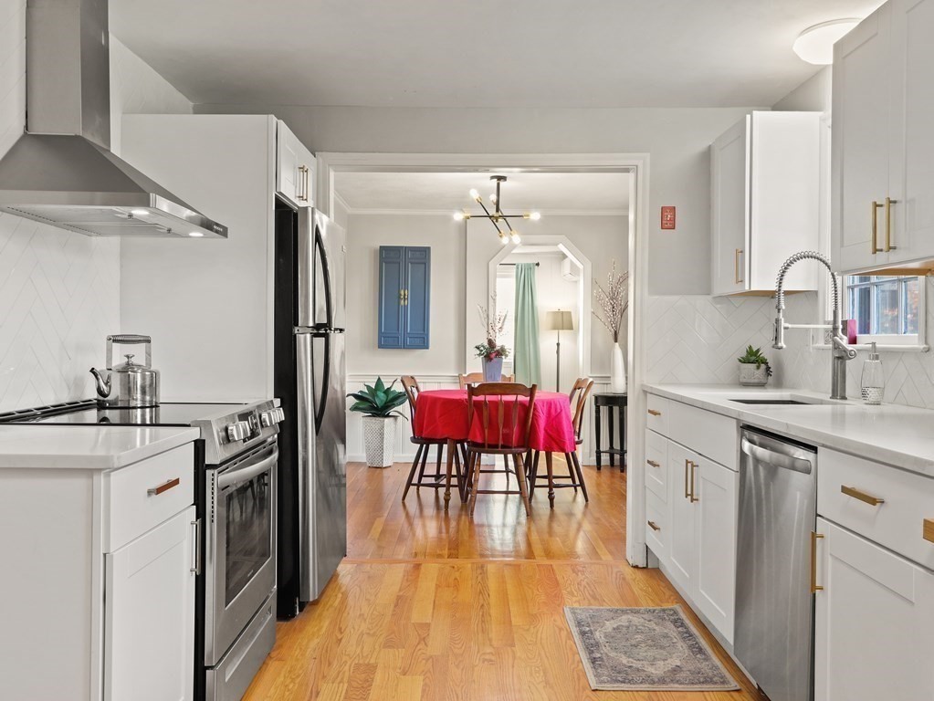 93 Meadowbrook Road Needham, MA 02492 - Photo 3 of 34 a kitchen with a stove a sink and a refrigerator