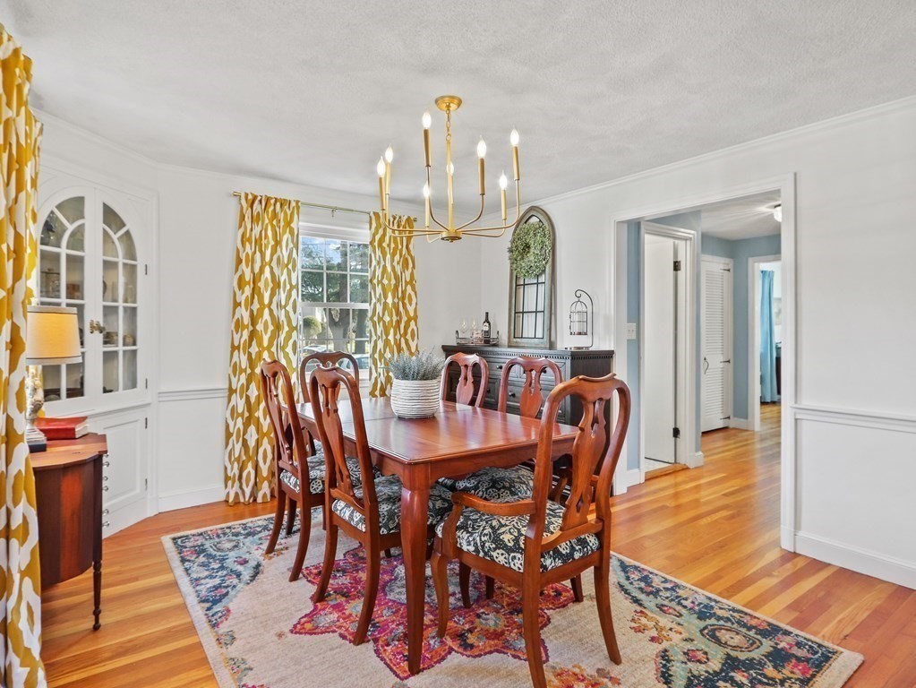 93 Meadowbrook Road Needham, MA 02492 - Photo 7 of 34 a dining room with furniture a chandelier and wooden floor