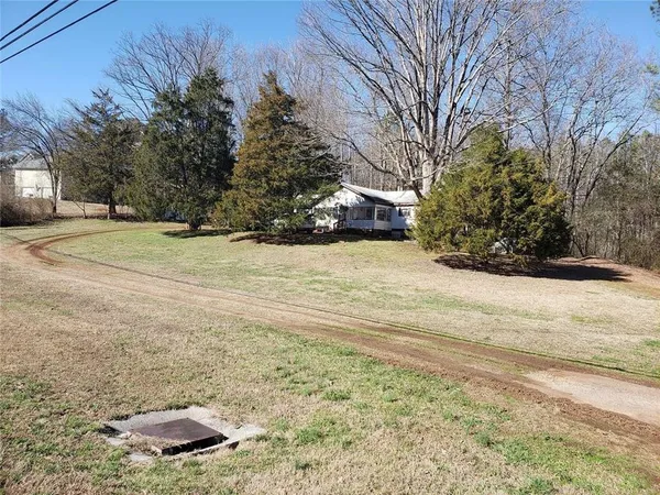 a view of a yard with trees